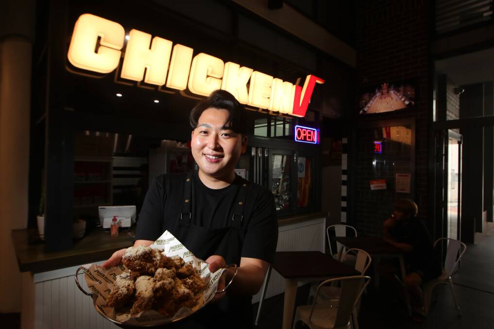 Many flavours: Chicken V owner Harry Jeong with a plate of the new shop's best. Picture: Sylvia Liber