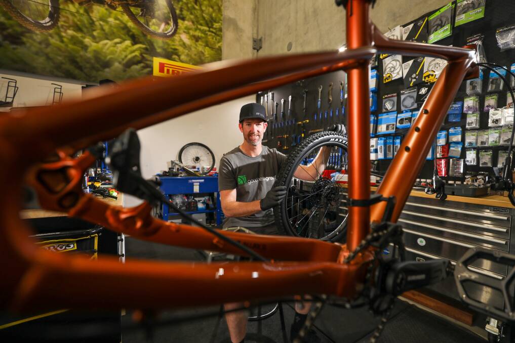 Tune up: Dan Irwin in his Helensburgh bike workshop is encouraging other businesses to start thinking about how to make the most of Wollongong 2022. Picture: Adam McLean