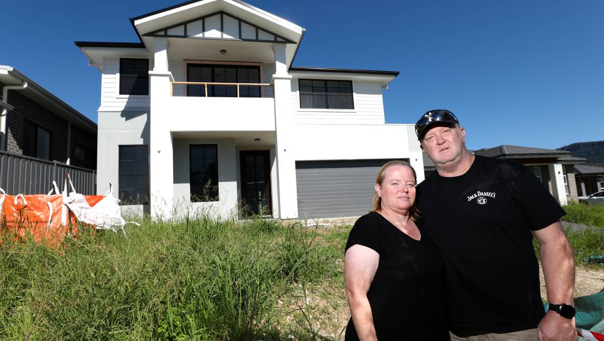 Kelly and Tony Sharples outside their unfinished home in February 2023. Picture by Adam McLean