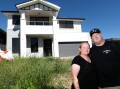 Kelly and Tony Sharples outside their unfinished home in February 2023. Picture by Adam McLean