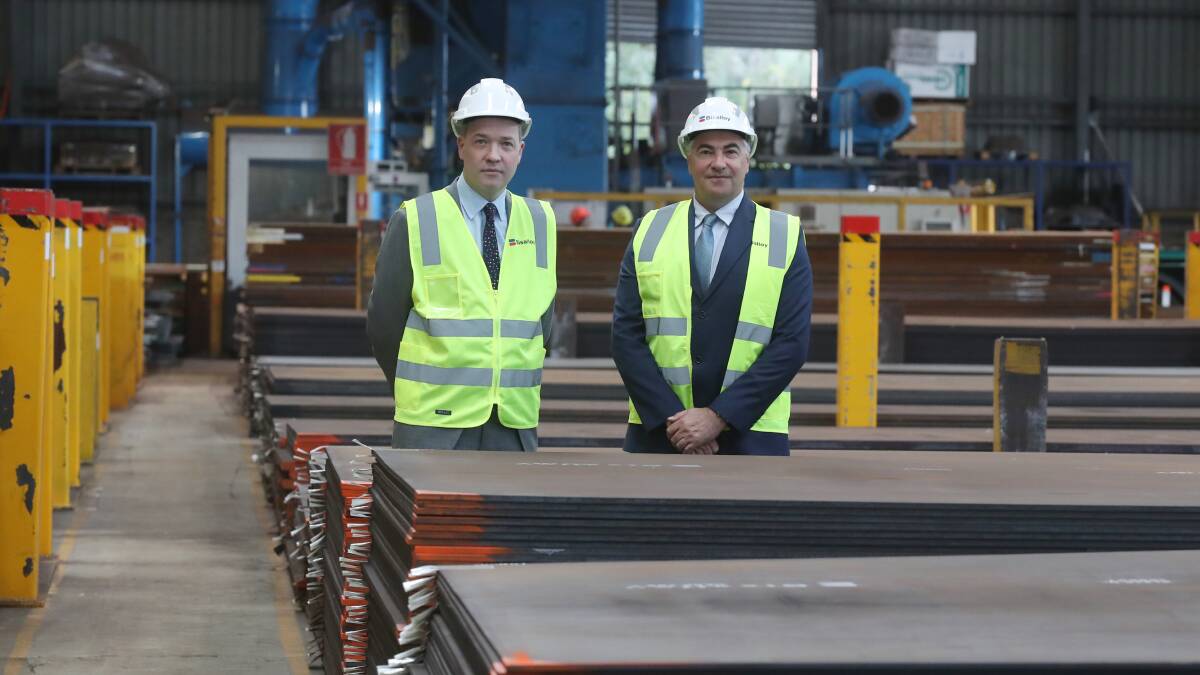 Adam Zarth, Business Illawarra and Andrew Huckstepp, Bisalloy,with some of the Illawarra steel used in defence projects. Picture by Robert Peet