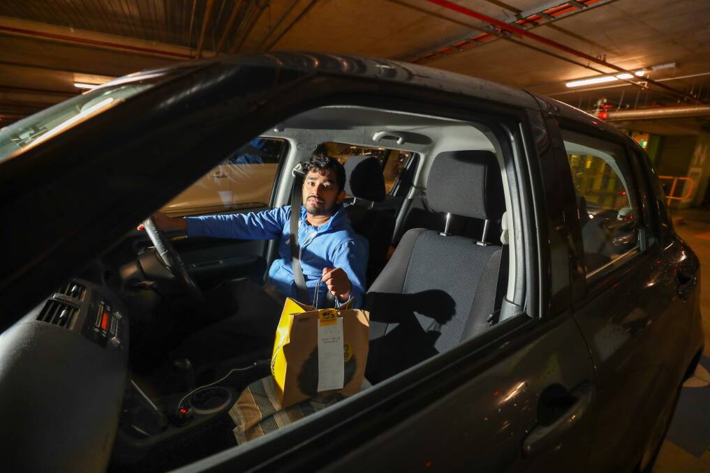 On the road: Devi Naga Srinivas Chilukuri picks up a delivery in Wollongong. Picture: Adam McLean
