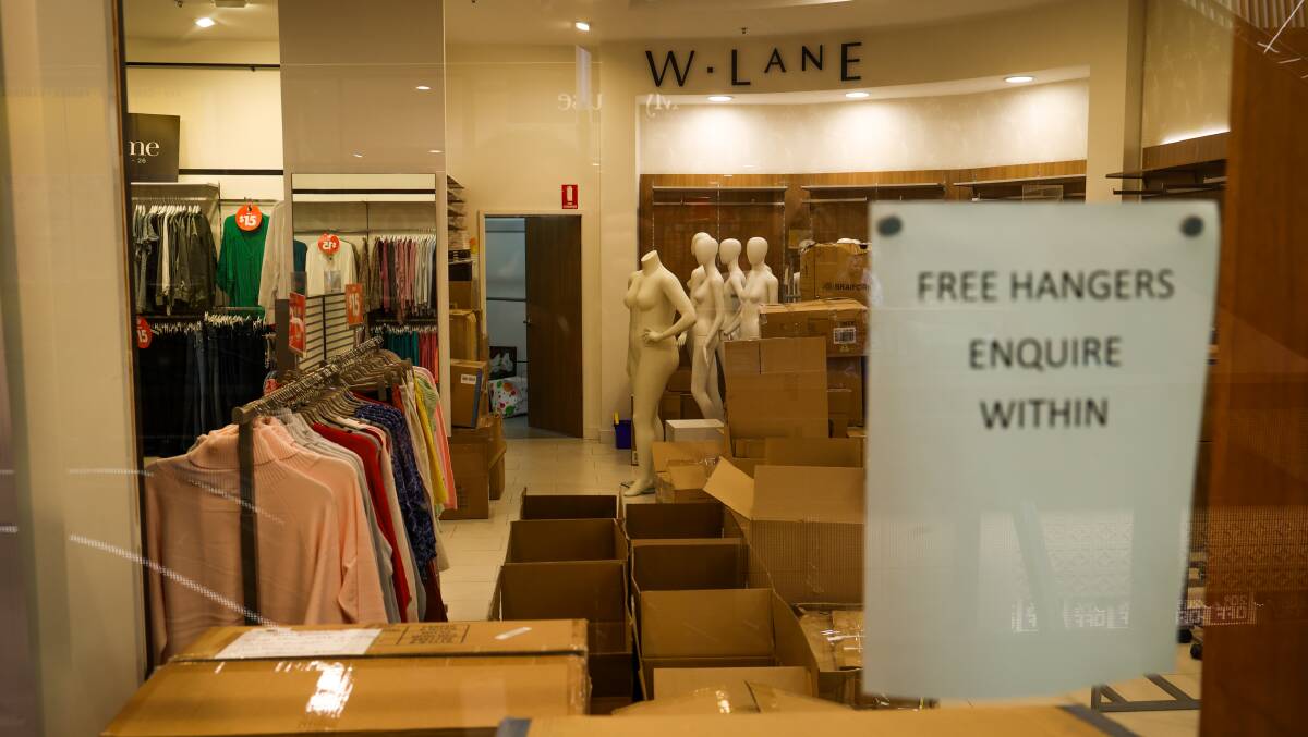 A sign in the window of W. Lane offers free hangers as stock is heavily discounted in store. Picture by Wesley Lonergan