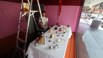 Madeline Hoy preparing her arrangement in the 'Shop' at the Egg & Dart gallery in Wollongong. Picture by Robert Peet
