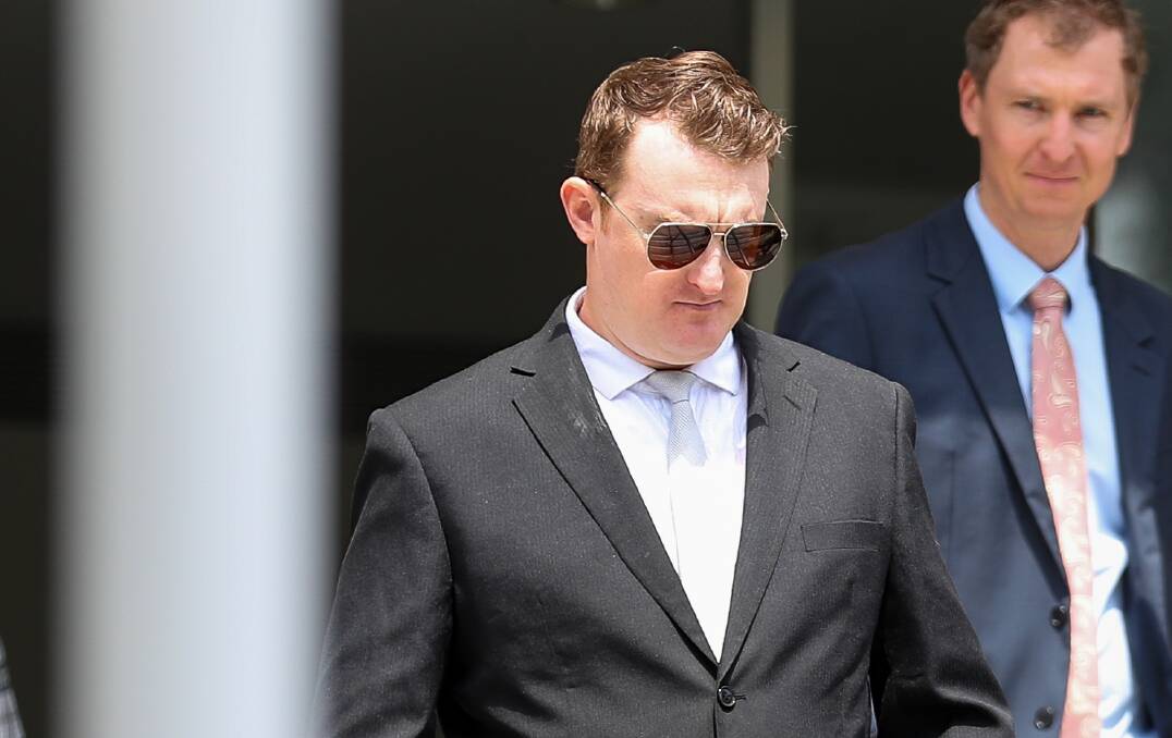 Stephen Fenn (centre), with solicitor Harry Lollback, leaving Wollongong courthouse. Picture by ACM