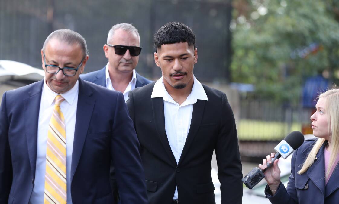 Junior Amone (middle) arriving at Wollongong courthouse on October 18, alongside lawyer Elias Tabschouri (left) and manager Mario Tartek (behind). Picture by ACM