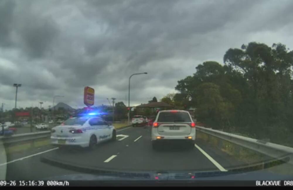A still of dash cam footage showing police pursuing the red van through the Figtree off ramp on September 26. Picture from Tik Tok