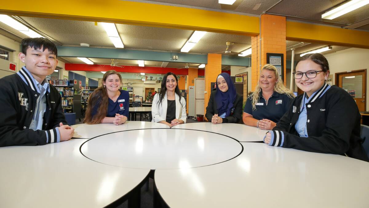 Warrawong High teacher Nisrine Hijazi with Year 12 students Esma Aksu, Andrew Wong and Tiannah Coelho and The Smith Family partnership coordinator Alison Bell and program coordinator Sarah Conroy. Picture by Adam McLean.