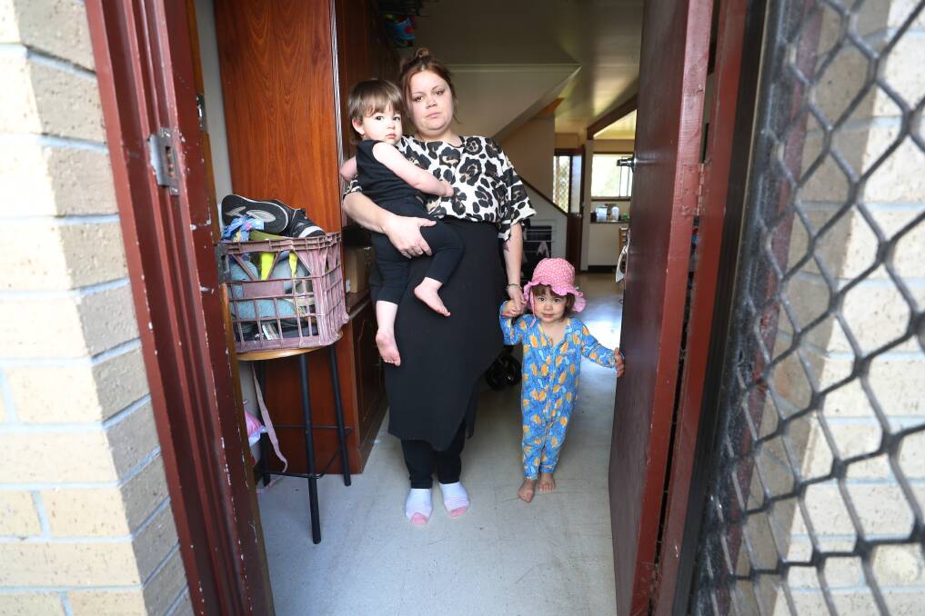 Caitlin with her two young children at her mother's house where they are living in the meantime. She says it's overcrowded, and worsening her health conditions. Picture by Robert Peet.