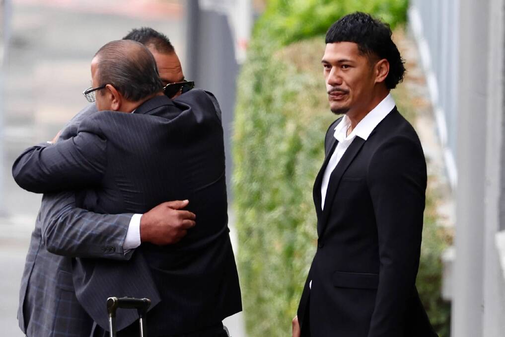 Defence lawyer Elias Tabchouri and Talatau Amone hugging (left) and stood-down Dragons player Junior Amone before entering Wollongong courthouse on December 11. Picture by Adam McLean