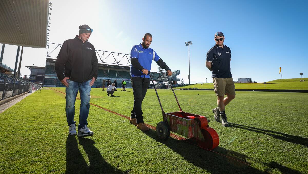 Prepped and primed: TAFE Yallah sports turf management teacher David Little with students Michael Lee and Jamie McNamara, who had the opportunity to prep the largest field in the region ahead of the Dragons clash with the Rabbitohs. Picture: Adam McLean.