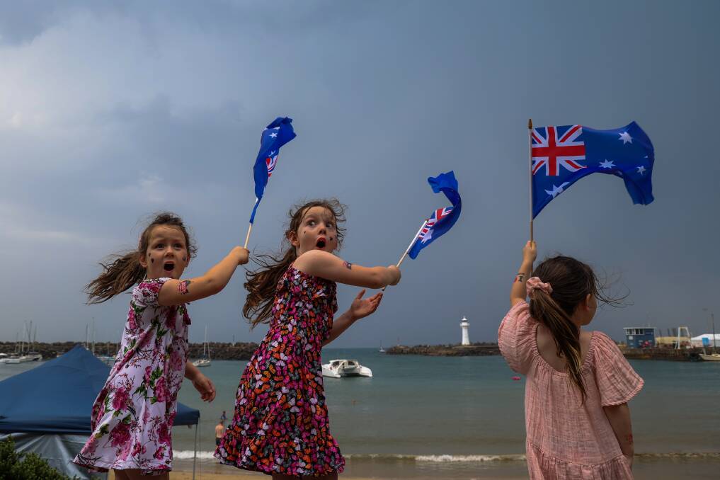 Matilda, Nova and Aurora Pickering braved the weather as the thunderstorm cleared out the crowd. Picture by Wesley Lonergan.