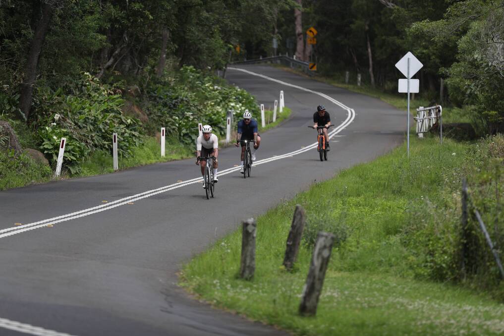 Ryan Petrie (front) during his 'Everesting' challenge that involves going up and down Mount Keira until he has climbed the equivalent of Everest twice. Picture by Robert Peet
