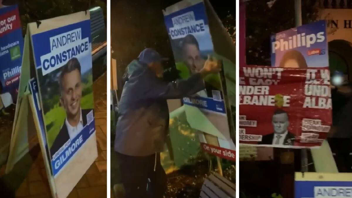 Caught out: Libs volunteer covers Labor signs at Gerringong