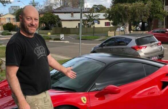 Darryl Simmonds, of East Corrimal, posing with a luxury car. Picture from Facebook