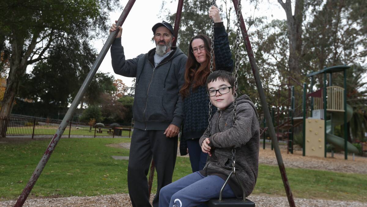 SWINGING IN LIMBO: Paul and Jodie Kuhne with their son Khan, 10. Pictures: TARA TREWHELLA.