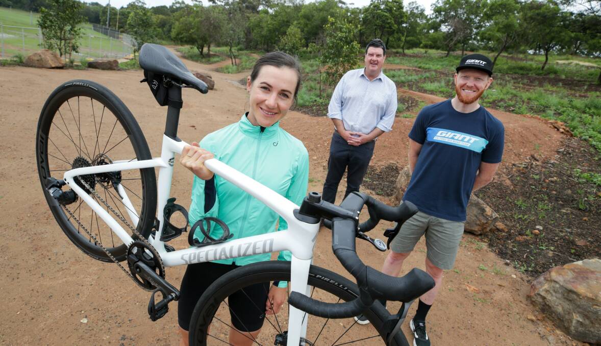Wollongong City Council general manager Greg Doyle and Bike City ambassadors Samara Sheppard and Josh Carlson visit Cringila Park's new mountain bike trails. 