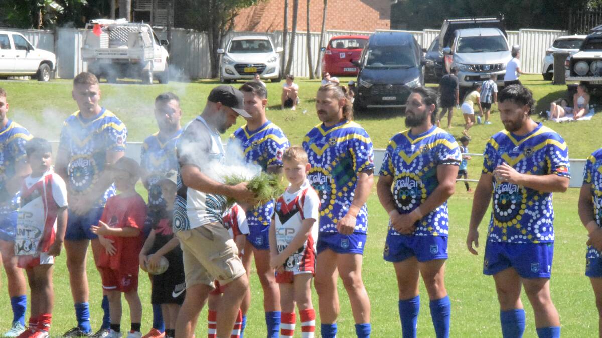 Drew Longbottom performing a smoking ceremony prior to kick off in the men's match. Picture by Sam Baker 