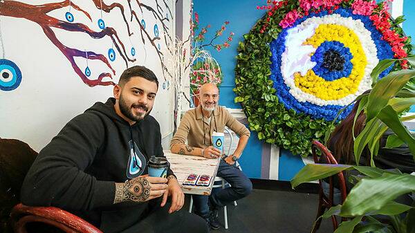 Eye-eye: Kayahan Gunes and his father Steve at their eatery, the Evil Eye Cafe in Fairy Meadow. Picture: Adam McLean