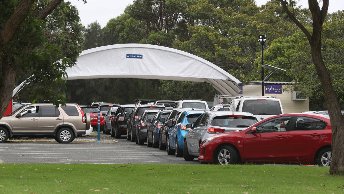 Case number explosion: Cars queue at the Histopath Pathology Drive COVID testing clinic at Northcliffe Drive, Warrawong, on Monday. Picture: Robert Peet