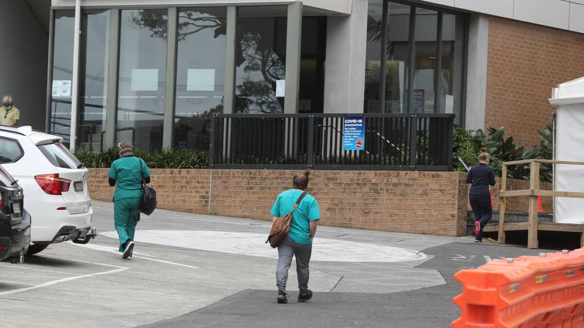Under pressure: Wollongong Hospital staff on their way into the building today. ISLHD has revealed about 150 of its staff are unable to work on any given day due to COVID-19 isolation requirements. Picture: Robert Peet