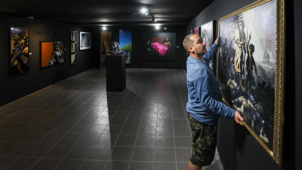 Blank canvas: Black Box Artspace director Luke Cornish puts the finishing touches on the first exhibition to take place at his new Wollongong art gallery. Picture: Adam McLean