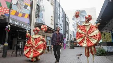 Louise Clark (stilts) and Nat Harris from Circus Monoxide with Adam Smith from Yours and Owls in Globe Lane. Picture: Adam McLean
