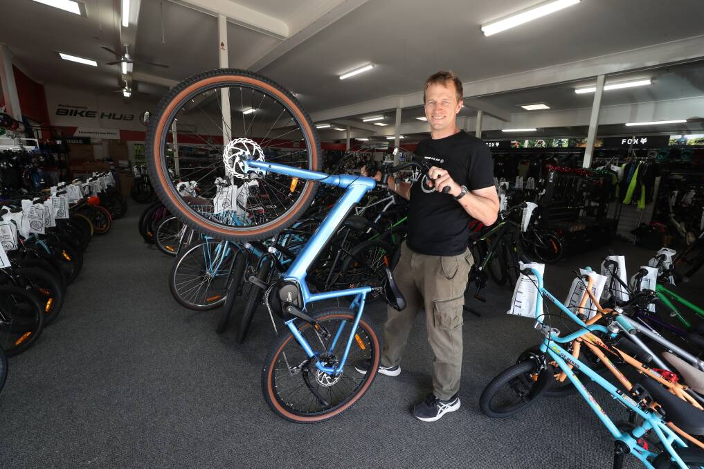 Wollongong Bike Hub Manager Gerard Hilford with an electric bike at the Keira Street store. Picture by Robert Peet