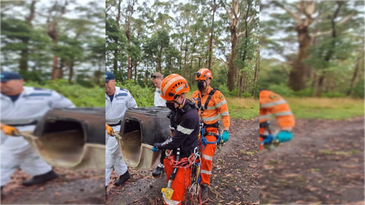 Rescue personnel with the kennel police believe was thrown from a cliff. Picture from NSW Police Force