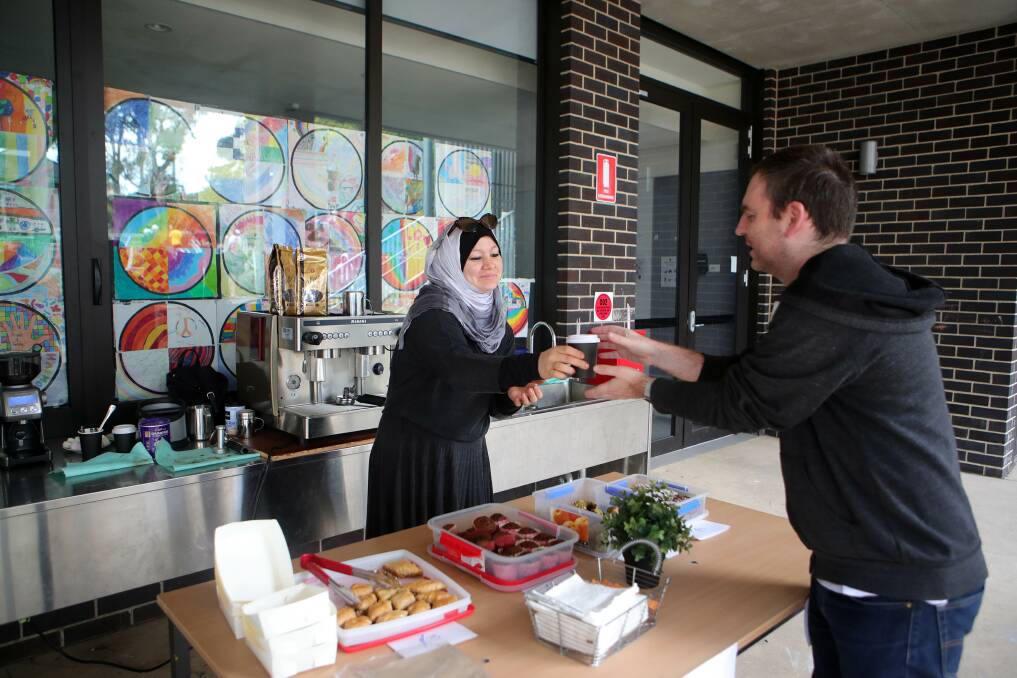 Matthew Berryman getting coffee by Kawther Daken from the Wollongong Primary Community Hub. Picture: Sylvia Liber.
