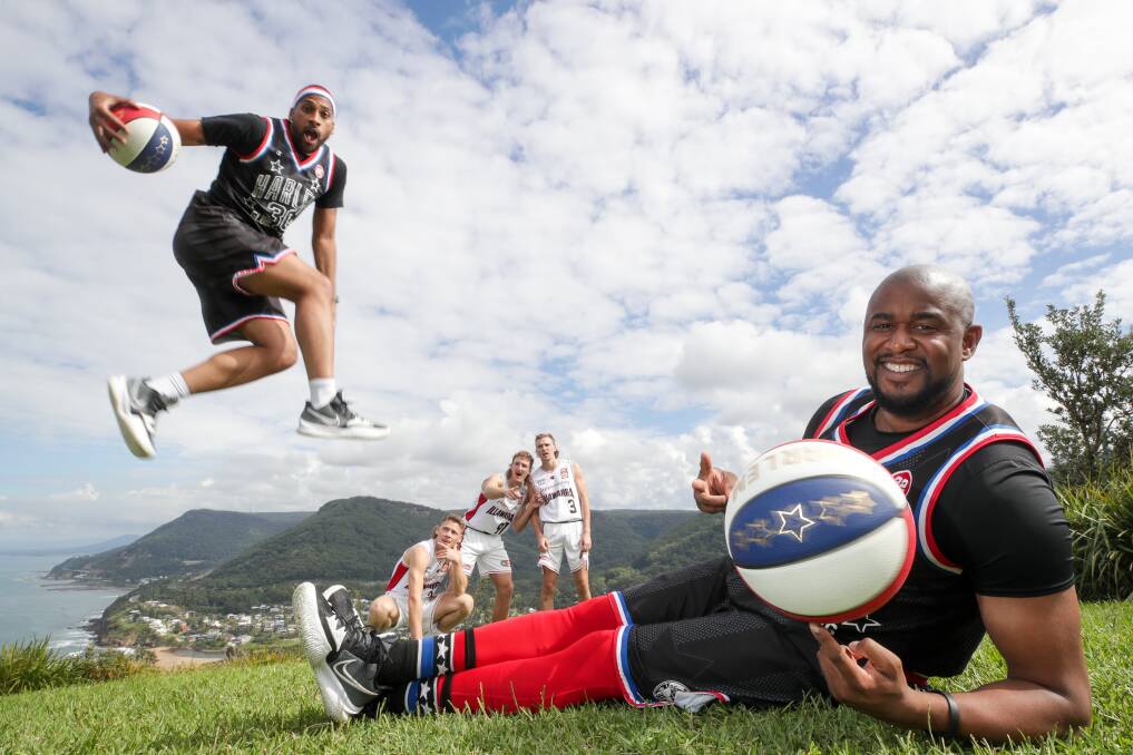 Globetrotters Julian "Zeus" McClurkin and Scooter Christensen with Hawks players at Bald Hill in Stanwell Tops in April. Picture:Adam McLean