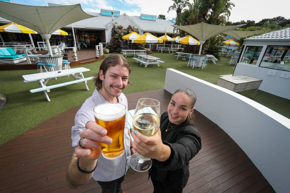 Festive: Kathy Wilson and Jaron Isemonger from Towradgi Beach Hotel raise a glass. Picture:Adam McLean
