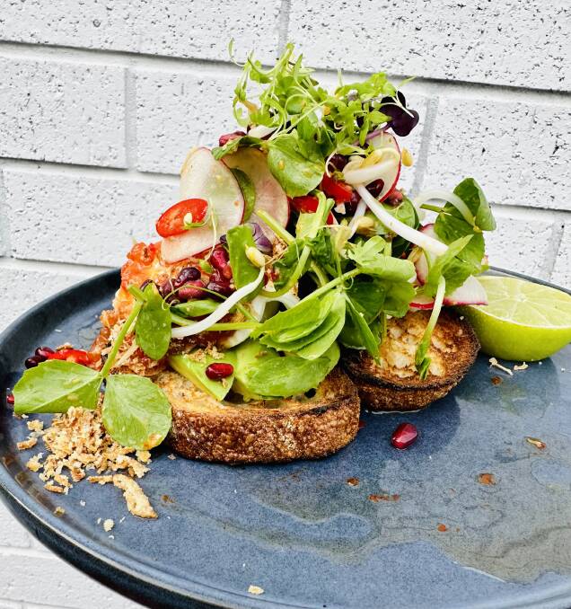 Free-range poached eggs with chilli jam, avocado, radish, pomegranate, nahm jim, chilli, fried shallots, bean shoots, snow pea tendrils, coriander and lime on toasted sourdough at Se7en Cafe. Picture supplied