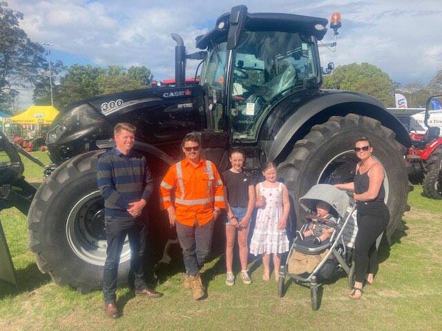 Anthony Warr, the proud owner of the rare black tractor with his family and Daniel Arthur at the Berry Small Farm field day. Picture supplied. 