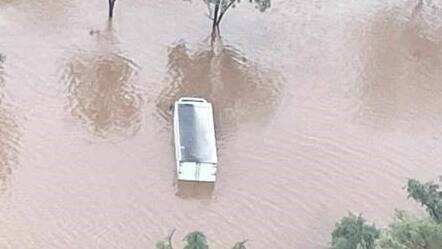 HeliMuster had to rescue four occupants from a car surrounded by floodwaters near the Victoria River Roadhouse. Picture NT Police.