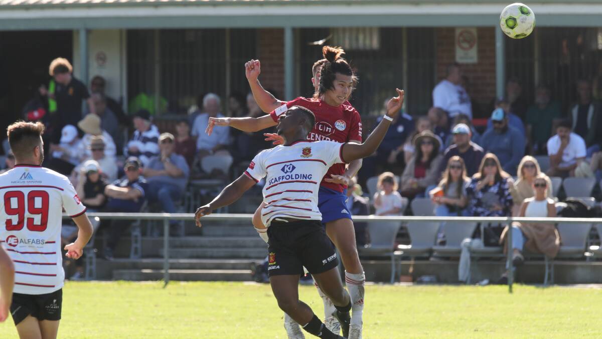 Renji Shimizu and Ekoue D'almeida during the bumper clash between Albion Park and Cringila on Good Friday where the White Eagles got up 2-1. Picture by Sylvia Liber