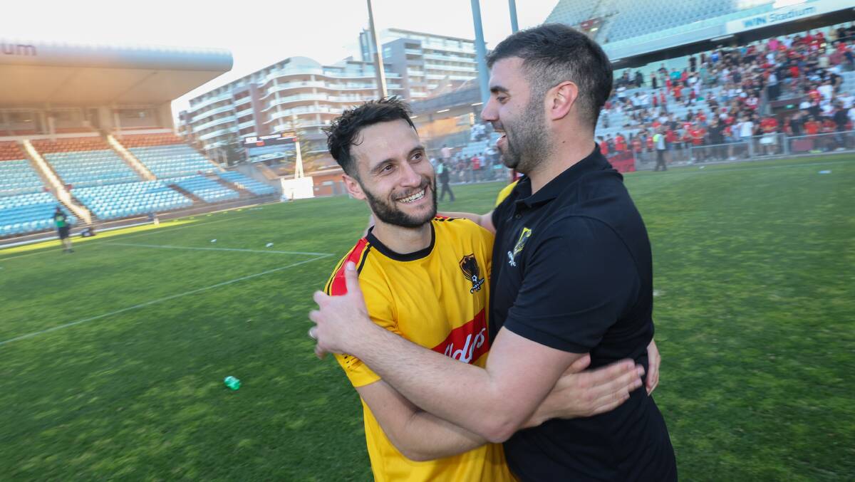 Franc Pierro (right) celebrates with the grand final match winner, Matthew Floro. Picture by Adam McLean