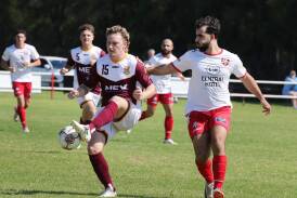 Joel Grono from Picton and Nickita Peros battle for possession during the Wanderers' 4-0 Bert Bampton Cup win at King Mickey Park on Good Friday. Picture by Sylvia Liber