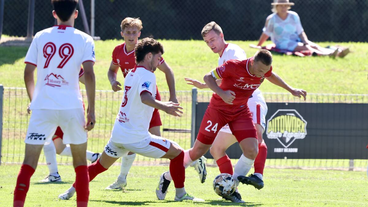 Lachlan Scott battles with the St George defence during their 1-1 draw at Albert Butler Memorial Park. Picture by Sylvia Liber
