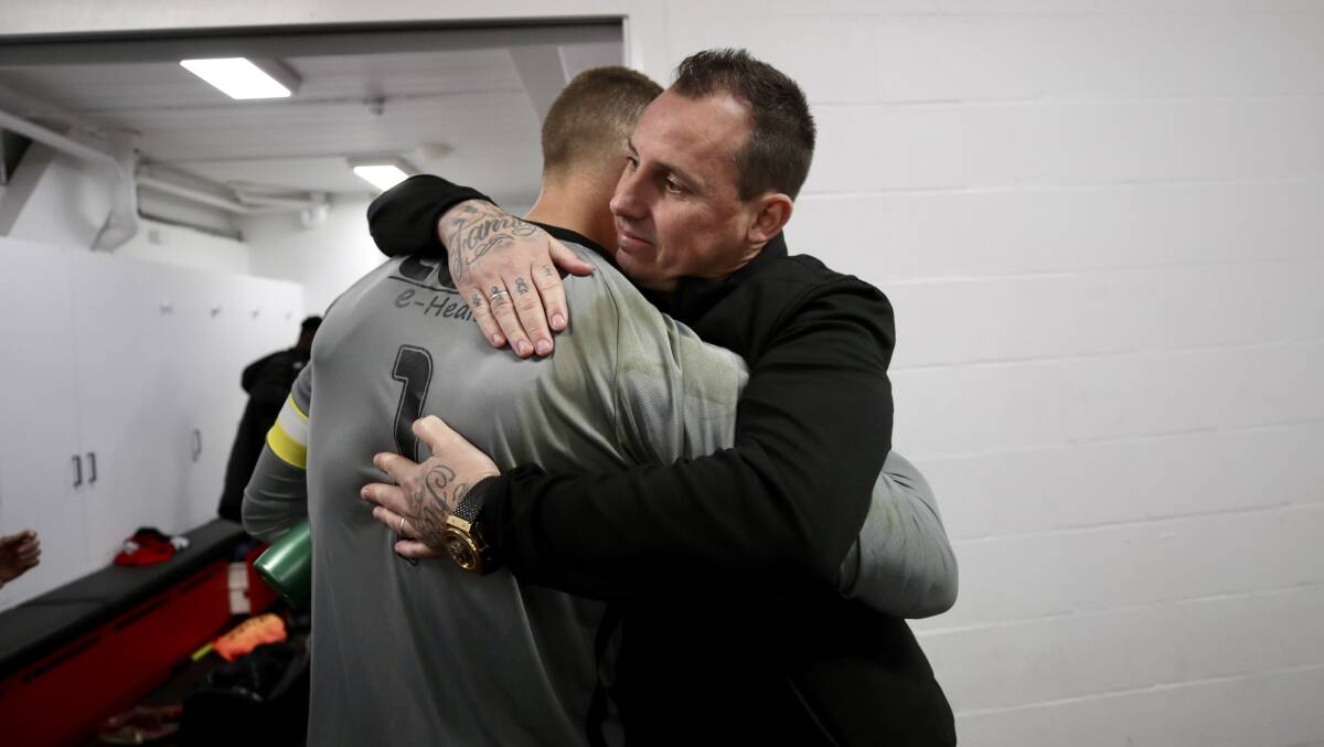 Emotional: Wolves goalkeeper Hayden Durose hugs his outgoing coach. Picture: Adam McLean