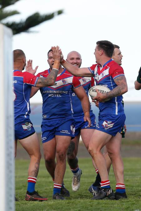 The Lions players celebrate after one of their tries against the Stingrays on Saturday. Picture by Anna Warr