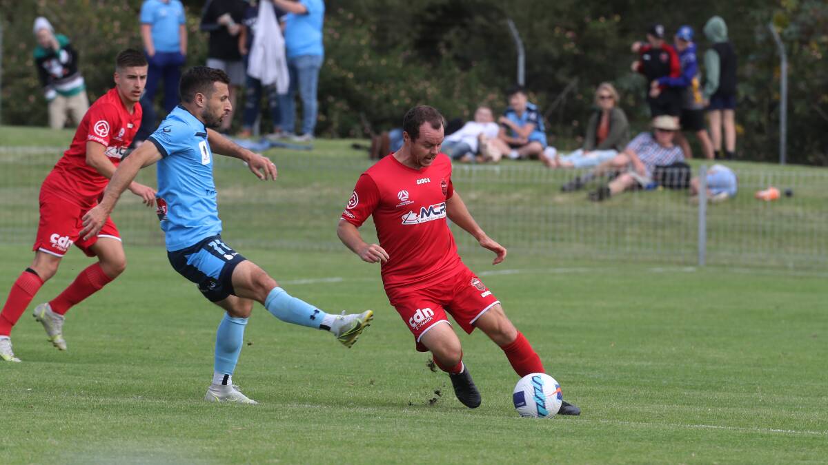 Primed: Brendan Griffin going up against then-Sydney FC forward Kosta Barbarouses in a pre-season friendly. Picture: Robert Peet 