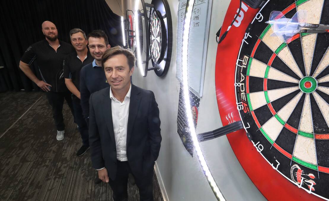 Excited: Night Owls Darts Club members Kristian Evans and Glen Gibson with Tennis Club manager Andrej Gacesa and vice president Mark Johnston. Picture: Robert Peet