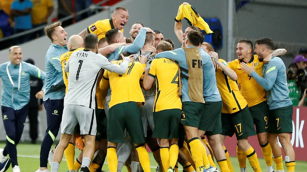 The Socceroos celebrate with 'grey wiggle' Andrew Redmayne following his heroics in their penalty shoot-out victory against Peru in Doha in World Cup qualifying earlier this year. Picture - Getty 