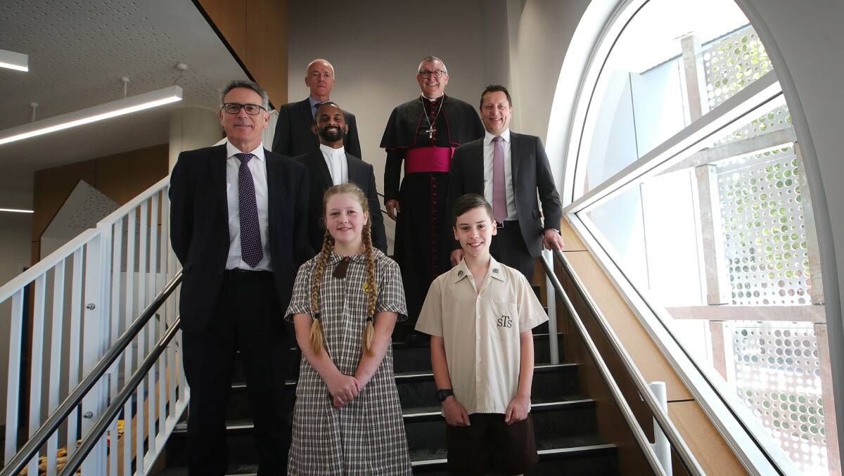 Year six students Georgia Cummins and Seth Momirovski with (clockwise) Director of Schools Catholic Education Diocese of Wollongong Peter Hill, Father Duane Fernandez-Parish Priest, St Therese principal Stephen Thorne, Bishop of Wollongong Brian Mascord, Wollongong MP Paul Scully. Picture by Sylvia Liber