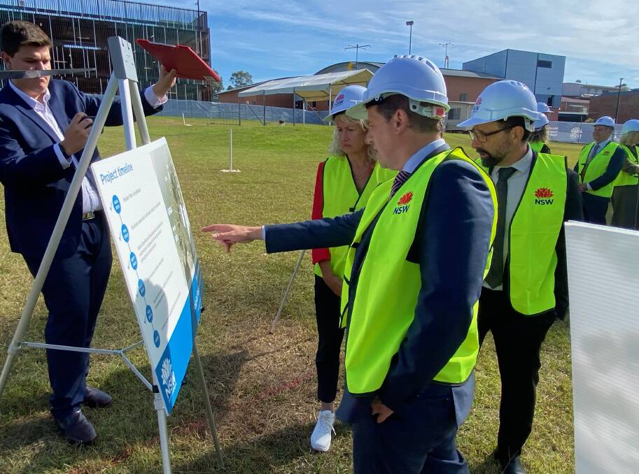 State Member for South Coast, Liza Butler, and NSW Health Minister Ryan Park are joined by John Holland representatives as they look over plans for Shoalhaven Hospital's redevelopment. Picture by Glenn Ellard.