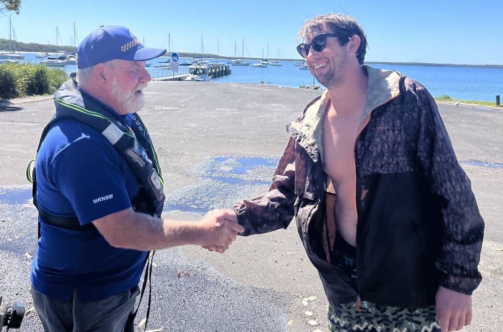 Angler Todd Alleyn thanks Jervis Bay Marine Rescue Unit Commander Kevin Hill after he was picked up following his boat capsizing this morning. Picture supplied.