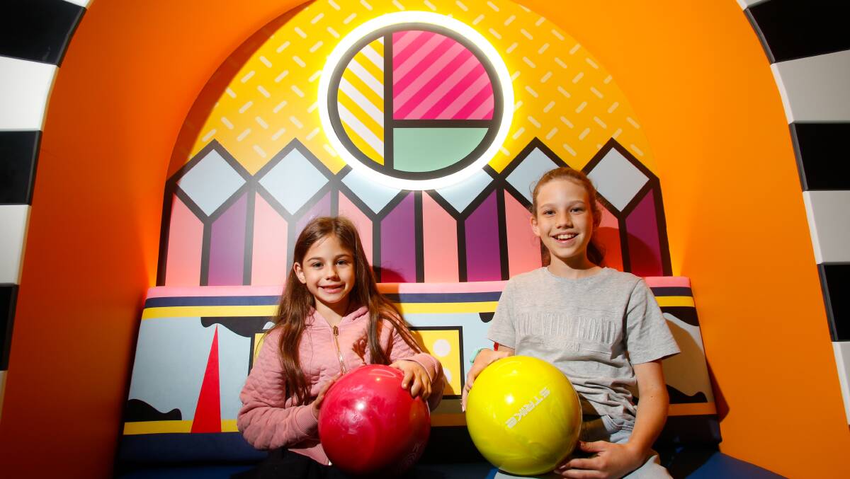 7-year-old Sofia and 10 year-old Zara strike a pose at the new Strike Bowling in Wollongong Central. Picture by Anna Warr