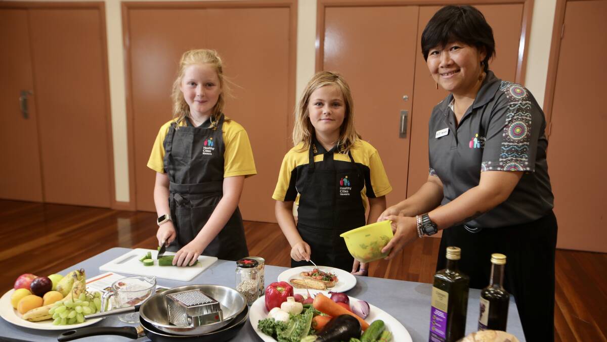 Shayla Fittler, 11, and nine-year-old Charli Orr with Manami Henderson, health promotion officer at Healthy Cities. Picture by Sylvia Liber.
