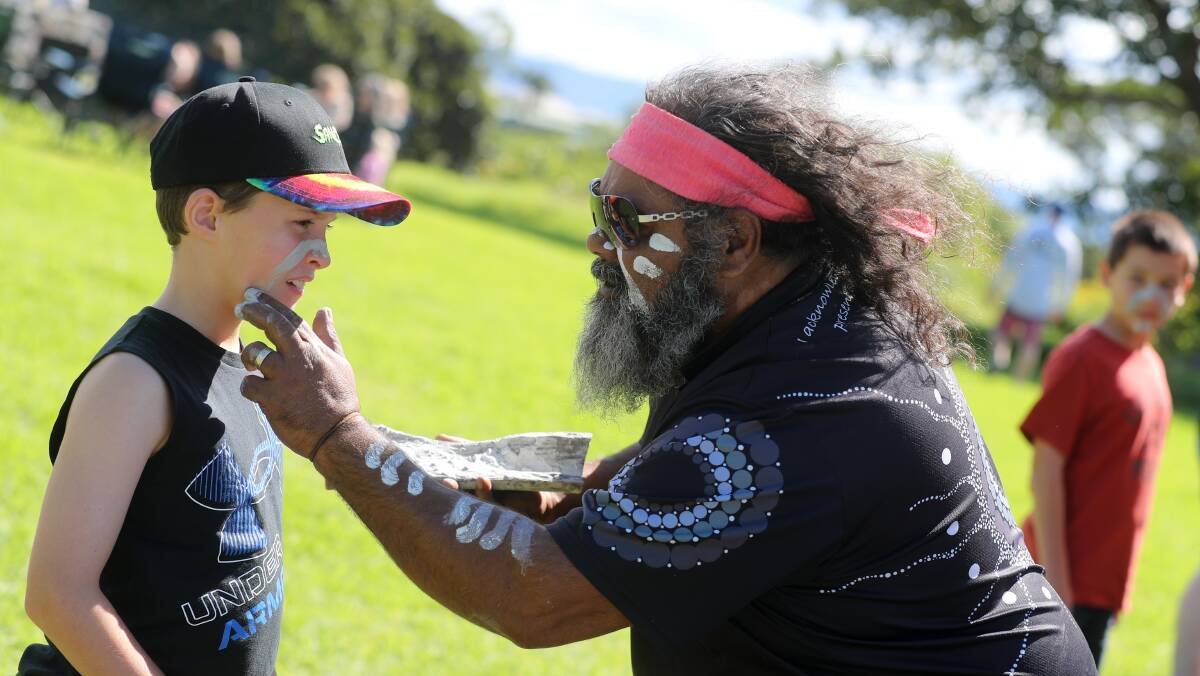Gumaraa Aboriginal Experience founder Richard Campbell and 8-year-old Alexander Moreton from Shell Cove during the Ochre Ceremony, part of The Farm Kiosk 1st birthday celebration activities at Killalea Reserve. Picture by Robert Peet.